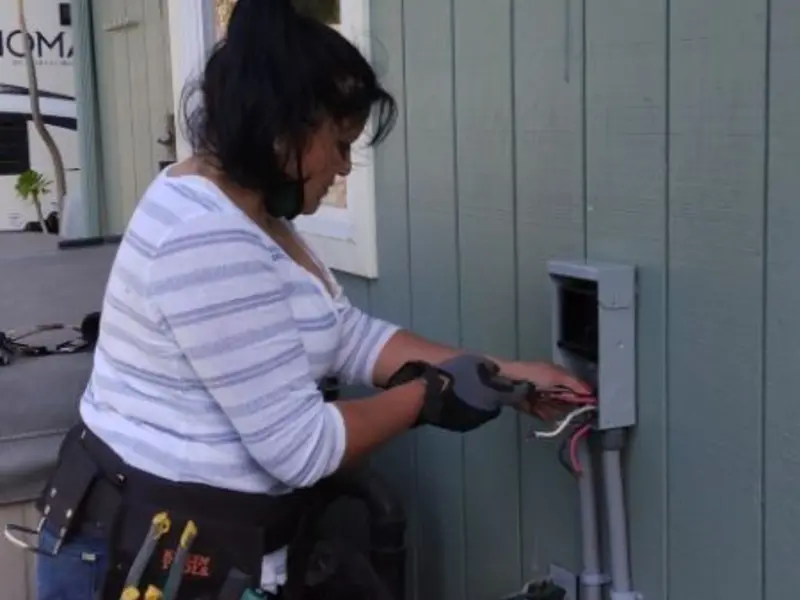 Licensed electrician wiring an exterior subpanel in West Modesto